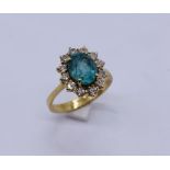 A diamond and emerald cluster ring set in 18ct gold- the emerald measuring approx. 9mm x 7mm