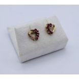 A pair of 9ct gold heart shaped earrings set with rubies