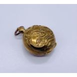 A brass Art Nouveau sovereign case depicting a swan