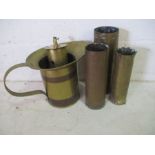 Five pieces of brass ware including a jug ,a shell with ballerina trench art, broad arrow marked