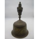 A large late 19th Century Indian cast and engraved bronze hand bell, the handle modelled as the