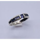 A 9ct gold and tanzanite half eternity ring