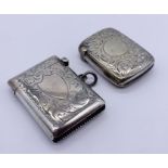 A hallmarked silver vesta case along with a silver plated version