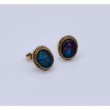 A pair of opal earrings set in unmarked 9ct gold