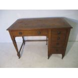 An oak ladies writing desk with leather top