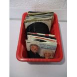 A collection of 7" vinyl singles including Elvis Presley, Rolling Stones, Queen, Roy Orbison, Tom