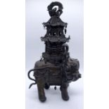 A 19th century Eastern bronze incense burner formed as an elephant with raised trunk, supporting a