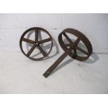 A pair of cast iron wheels with axel