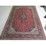 A large red ground Persian carpet 4.6m x 3m