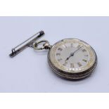 A fine silver fob watch with tooled silver dial with gold detailing