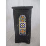 A small narrow cupboard with Islamic style tiles to door, height 45cm