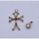 A 9ct gold cross along with a 9ct pendant, total weight 2.4g