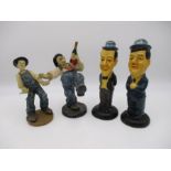 Two pairs of Laurel & Hardy figurines