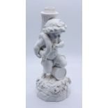 A Meissen figure of a Putti playing a sousaphone like horn ( horn missing) kneeling on a drum,