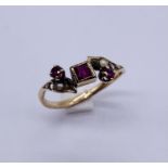 A 9ct gold ruby and seed pearl dress ring ( 2 seed pearls missing)
