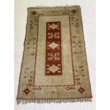 A Turkish hand woven rug - overall size 178cm x 112cm