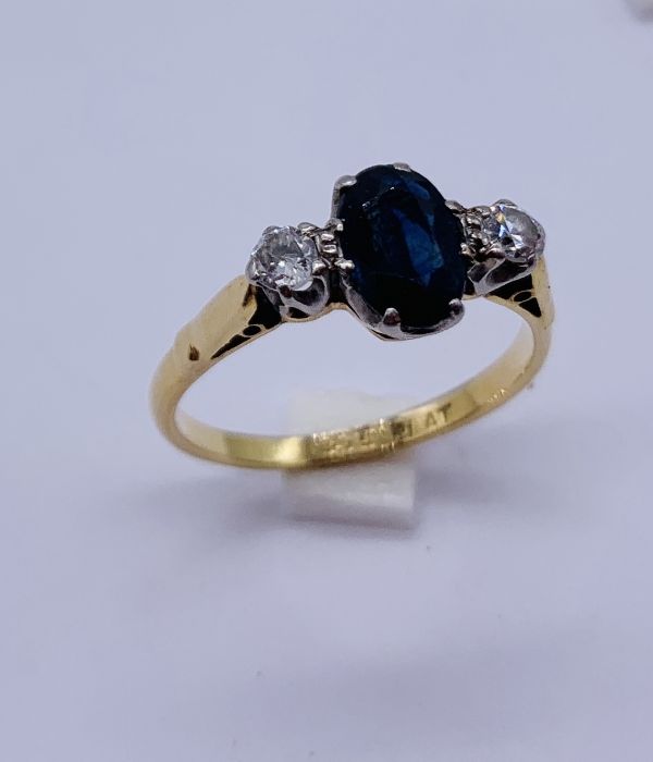 An 18ct gold and platinum sapphire and diamond three stone ring