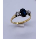 An 18ct gold and platinum sapphire and diamond three stone ring