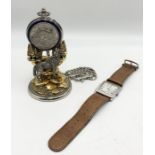 A Franklin Mint pocket watch with wolf design on stand along with a Furla watch