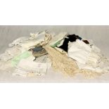 A collection of vintage linen, clothing etc