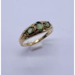 A 9ct gold dress ring with pale green stones