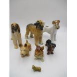 A collection of seven ceramic dogs including a Sylvac Afghan Hound, Copper Craft, Corgi Wade Mini,