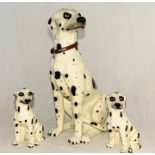 A large porcelain Dalmatian (Damage to the foot as shown) along with two smaller versions.
