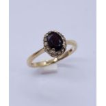 A 9ct gold dress ring set with garnet coloured stone