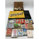 A selection of vintage games including a set of bone dominoes, Snow White playing cards etc.