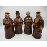 A collection of four novelty decanters, two in the form of monks