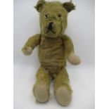 An antique teddy bear with jointed limbs