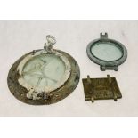 Two vintage portholes, along with ammunition cover