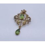 An Art Nouveau 9ct gold pendant set with peridot and seed pearls