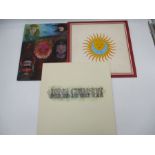 A collection of three King Crimson 12" vinyl albums including In The Wake Of Poseidon (textured