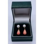 A pair of hallmarked 9ct gold drop earrings each with a coral drop under a pearl