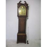 A Georgian mahogany long case clock, with swan neck finials. Inlaid with brass face bearing the