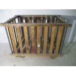 A slatted wooden industrial bobbin trolley