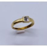 An 18ct gold ring set with four small diamonds