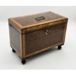 A walnut veneered tea caddy with inlaid detailing and shell design