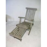A teak steamer chair.