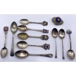 Three hallmarked silver tea spoons along with a collection of EPNS versions and a brooch