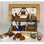 A vintage dolls house along with a collection of dolls house furniture