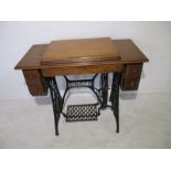 A vintage Singer treadle sewing machine with cast iron base