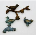 Two vintage brass taps in the form of birds along with one other