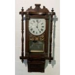 An Edwardian wall clock with fretwork decoration