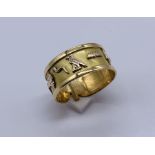 An 18ct gold (tested) Egyptian wedding band decorated with various hieroglyphs, weight 3.5g