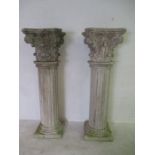 A pair of weathered marble effect fluted columns with ornate separate capitals , height of columns