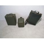 A collection of three vintage green petrol cans, one mounted for attachment to vehicle
