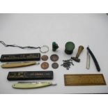 A collection of miscellaneous items including cut throat razors, Eley's percussion caps tin, monocle