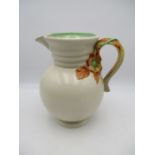 A Clarice Cliff bulbous jug with a relief moulded floral handle